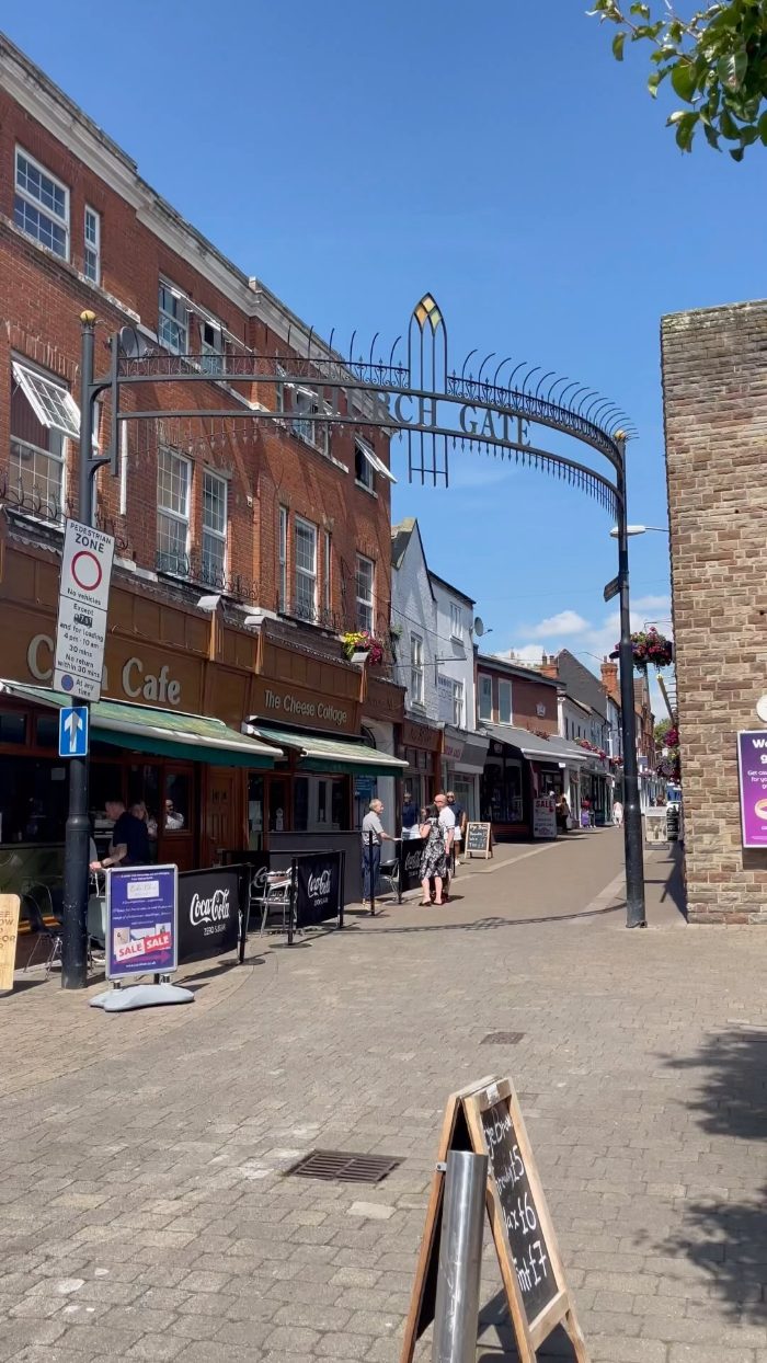 Church Gate, Loughborough: the pedestrianised street under its iron arch on a sunny day